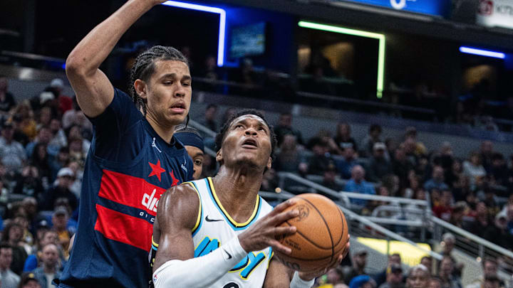 Nov 24, 2024; Indianapolis, Indiana, USA; Indiana Pacers guard Bennedict Mathurin (00) shoots the ball while Washington Wizards forward Kyshawn George (18) defends in the first half at Gainbridge Fieldhouse. Mandatory Credit: Trevor Ruszkowski-Imagn Images