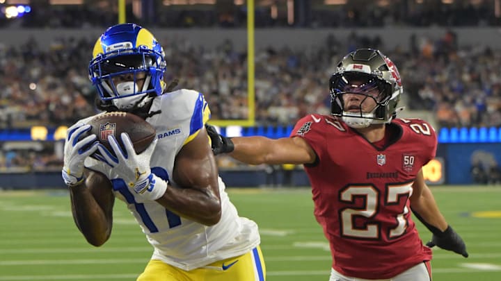 Nov 23, 2025; Inglewood, California, USA; Los Angeles Rams wide receiver Davante Adams (17) catches a one-yard touchdown pass thrown by quarterback Matthew Stafford (not pictured) against Tampa Bay Buccaneers cornerback Zyon McCollum (27) during the first quarter at SoFi Stadium. Mandatory Credit: Jayne Kamin-Oncea-Imagn Images
