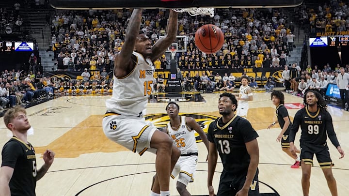 Feb 18, 2026; Columbia, Missouri, USA; Missouri Tigers center Shawn Phillips Jr. (15) dunks the ball as Vanderbilt Commodores forward Jalen Washington (13) looks on during the second half of the game at Mizzou Arena. Mandatory Credit: Denny Medley-Imagn Images