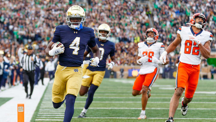 Notre Dame running back Jeremiyah Love (4) runs the ball into the end zone for a touchdown in the first half of a NCAA football game against Syracuse at Notre Dame Stadium on Saturday, Nov. 22, 2025, in South Bend. Notre Dame running back Jeremiyah Love (4) runs the ball into the end zone for a touchdown in the first half of a NCAA football game against Syracuse at Notre Dame Stadium on Saturday, Nov. 22, 2025, in South Bend.