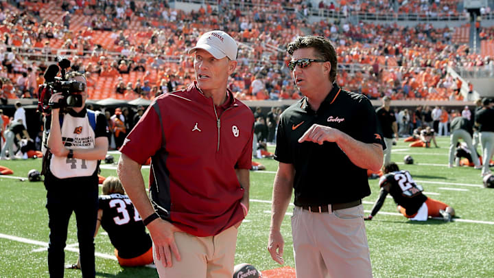 Oklahoma State coach Mike Gundy, right, and Oklahoma coach Brent Venables talk before a Bedlam college football game between the Oklahoma State University Cowboys (OSU) and the University of Oklahoma Sooners (OU) at Boone Pickens Stadium in Stillwater, Okla., Saturday, Nov. 4, 2023. Oklahoma State coach Mike Gundy, right, and Oklahoma coach Brent Venables talk before a Bedlam college football game between the Oklahoma State University Cowboys (OSU) and the University of Oklahoma Sooners (OU) at Boone Pickens Stadium in Stillwater, Okla., Saturday, Nov. 4, 2023.
