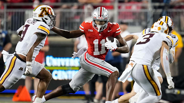 Ohio State Buckeyes wide receiver Quincy Porter (11) runs past Minnesota Golden Gophers linebacker Devon Williams (9) during the NCAA football game at Ohio Stadium in Columbus on Oct. 4, 2025. Ohio State won 42-3.