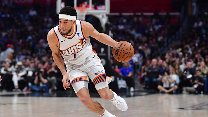 Apr 10, 2024; Los Angeles, California, USA; Phoenix Suns guard Devin Booker (1) controls the ball against the Los Angeles Clippers during the second half at Crypto.com Arena. Mandatory Credit: Gary A. Vasquez-Imagn Images
