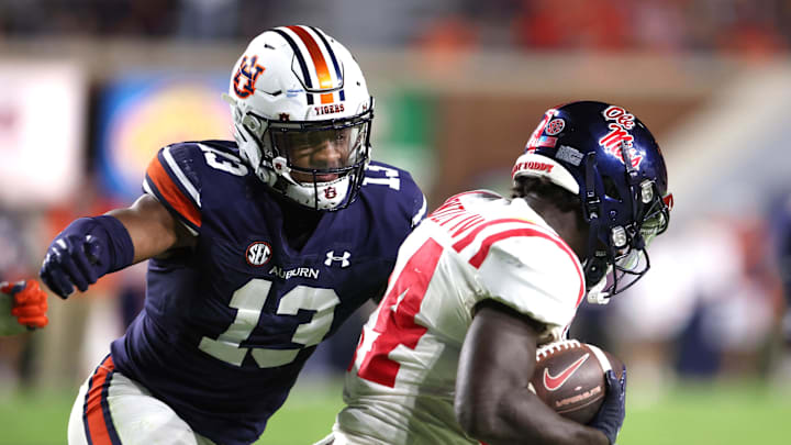 Oct 21, 2023; Auburn, Alabama, USA;  Auburn Tigers linebacker Cam Riley (13) closes in on Mississippi Rebels running back Ulysses Bentley IV (24) during the fourth quarter at Jordan-Hare Stadium. Mandatory Credit: John Reed-USA TODAY Sports