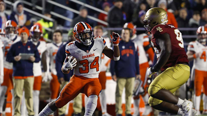 Nov 26, 2022; Chestnut Hill, Massachusetts, USA; Syracuse Orange running back Sean Tucker (34) cuts past Boston College Eagles defensive tackle Cam Horsley (96) during the second quarter at Alumni Stadium. Mandatory Credit: Winslow Townson-Imagn Images Nov 26, 2022; Chestnut Hill, Massachusetts, USA; Syracuse Orange running back Sean Tucker (34) cuts past Boston College Eagles defensive tackle Cam Horsley (96) during the second quarter at Alumni Stadium. Mandatory Credit: Winslow Townson-Imagn Images