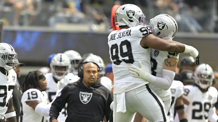 Sep 8, 2024; Inglewood, California, USA; Las Vegas Raiders defensive tackle Nesta Jade Silvera (99) celebrates with defensive end Maxx Crosby (98) a sack of Los Angeles Chargers quarterback Justin Herbert (10) in the first half at SoFi Stadium. Mandatory Credit: Jayne Kamin-Oncea-Imagn Images
