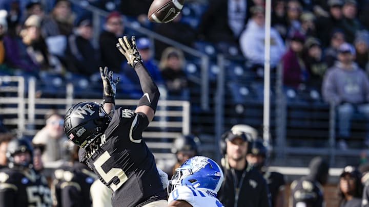 Nov 30, 2024; Winston-Salem, North Carolina, USA; Wake Forest Demon Deacons wide receiver Horatio Fields (5) makes the first touchdown catch defended by Duke Blue Devils cornerback Chandler Rivers (0) during the first half at Allegacy Federal Credit Union Stadium. Mandatory Credit: Jim Dedmon-Imagn Images