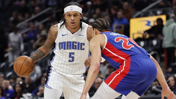 Feb 4, 2024; Detroit, Michigan, USA; Orlando Magic forward Paolo Banchero (5) dribbles defended by Detroit Pistons forward Kevin Knox II (24) in the first half at Little Caesars Arena. Mandatory Credit: Rick Osentoski-Imagn Images