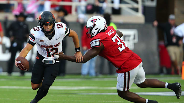 Oct 25, 2025; Lubbock, Texas, USA;  Texas Tech Red Raiders defensive end David Bailey (31) pressures Oklahoma State Cowboys quarterback Noah Walters (12) in the second half at Jones AT&T Stadium. Mandatory Credit: Michael C. Johnson-Imagn Images
