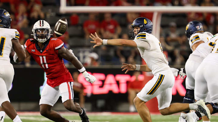 Sep 7, 2024; Tucson, Arizona, USA; Northern Arizona Lumberjacks quarterback Ty Pennington (6) tosses the ball to Northern Arizona Lumberjacks running back Seth Cromwell (34) while Arizona Wildcats defensive lineman Chase Kennedy (11) watches during the fourth quarter at Arizona Stadium. Mandatory Credit: Aryanna Frank-Imagn Images Sep 7, 2024; Tucson, Arizona, USA; Northern Arizona Lumberjacks quarterback Ty Pennington (6) tosses the ball to Northern Arizona Lumberjacks running back Seth Cromwell (34) while Arizona Wildcats defensive lineman Chase Kennedy (11) watches during the fourth quarter at Arizona Stadium. Mandatory Credit: Aryanna Frank-Imagn Images