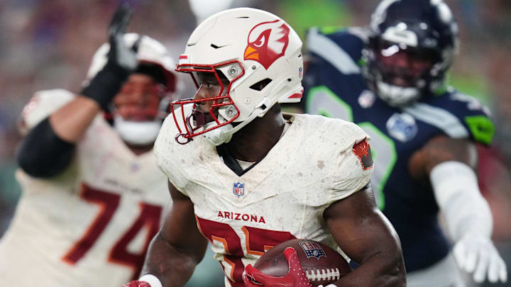 Arizona Cardinals running back Trey Benson (33) breaks out of the backfield against the Seattle Seahawks at State Farm Stadium in Glendale, on Sept. 25, 2025.