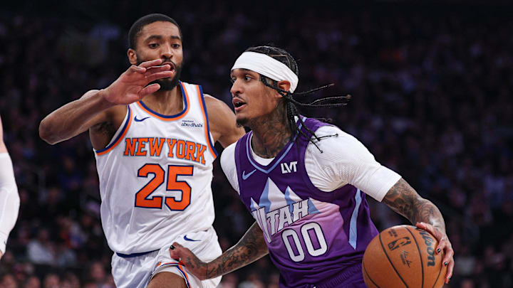 Jan 1, 2025; New York, New York, USA; Utah Jazz guard Jordan Clarkson (00) dribbles as New York Knicks forward Mikal Bridges (25) defends during the first half at Madison Square Garden. Mandatory Credit: Vincent Carchietta-Imagn Images