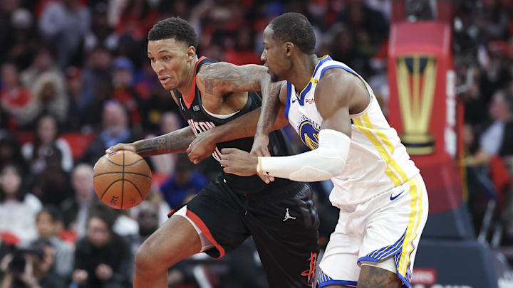 Dec 11, 2024; Houston, Texas, USA; Houston Rockets forward Jabari Smith Jr. (10) drives with the ball as Golden State Warriors forward Jonathan Kuminga (00) defends during the third quarter at Toyota Center. Mandatory Credit: Troy Taormina-Imagn Images