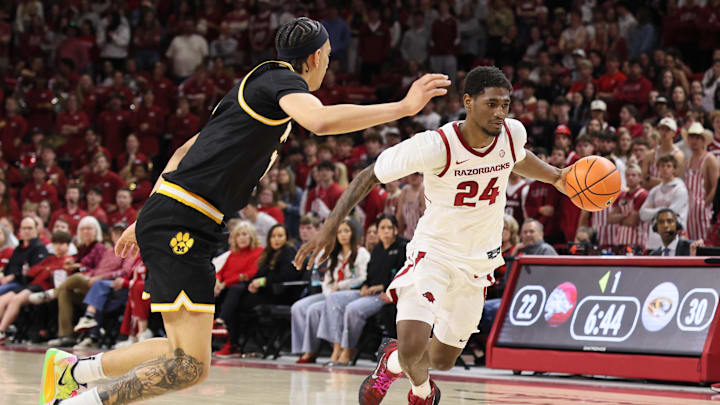 Feb 21, 2026; Fayetteville, Arkansas, USA; Arkansas Razorbacks wing Billy Richmond III (24) drives against Missouri Tigers guard Trent Pierce (11) during the first half at Bud Walton Arena. Mandatory Credit: Nelson Chenault-Imagn Images