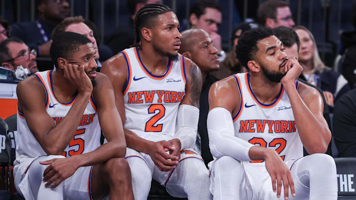 Nov 12, 2025; New York, New York, USA;  New York Knicks guards Mikal Bridges (25), Miles McBride (2), and center Karl-Anthony Towns (32) watch from the bench in the fourth quarter against the Orlando Magic at Madison Square Garden. Mandatory Credit: Wendell Cruz-Imagn Images