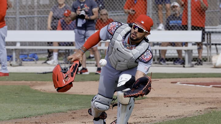 Feb 16, 2026; Jupiter, FL, USA;  St. Louis Cardinals catcher Ivan Herrera (48) fields a ball during spring training workouts at Roger Dean Stadium. Mandatory Credit: Reinhold Matay-Imagn Images
