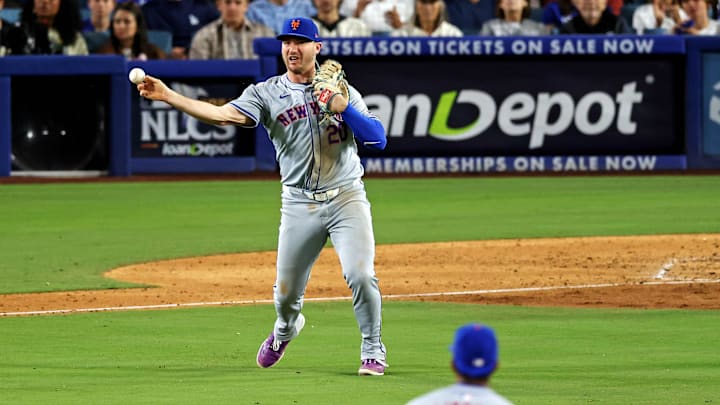 Oct 20, 2024; Los Angeles, California, USA; New York Mets first base Pete Alonso (20) throws late to second base allowing the runner to reach second base during the sixth inning during game six of the NLCS for the 2024 MLB playoffs at Dodger Stadium. 