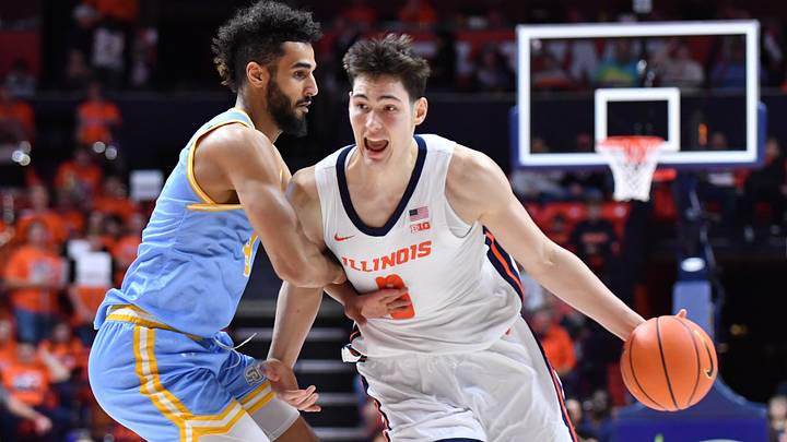 Dec 29, 2025; Champaign, Illinois, USA; Illinois Fighting Illini forward David Mirkovic (0) drives the ball against Southern University Jaguars forward Malek Abdelgowad (8) during the first half at State Farm Center. Mandatory Credit: Ron Johnson-Imagn Images Dec 29, 2025; Champaign, Illinois, USA; Illinois Fighting Illini forward David Mirkovic (0) drives the ball against Southern University Jaguars forward Malek Abdelgowad (8) during the first half at State Farm Center. Mandatory Credit: Ron Johnson-Imagn Images