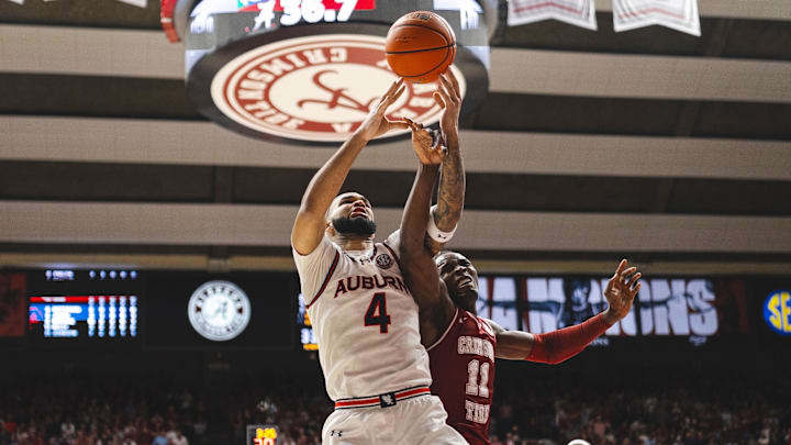 Feb 15, 2025; Tuscaloosa, Alabama, USA; Auburn Tigers forward Johni Broome (4) and Alabama Crimson Tide center Clifford Omoruyi (11) struggle over a rebound during the first half at Coleman Coliseum. Mandatory Credit: Will McLelland-Imagn Images