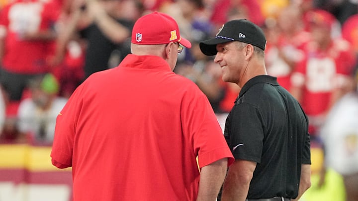 Sep 5, 2024; Kansas City, Missouri, USA; Kansas City Chiefs head coach Andy Reid, left, talks with Baltimore Ravens head coach John Harbough prior to a game at GEHA Field at Arrowhead Stadium. Mandatory Credit: Denny Medley-Imagn Images