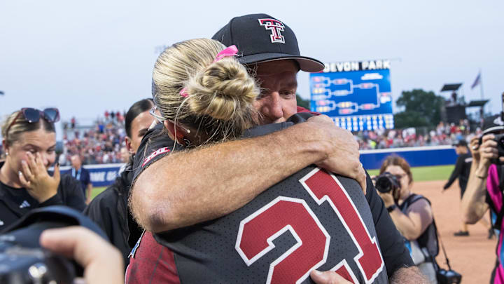 Jun 2, 2025; Texas Tech Red Raiders head coach Gerry Glasco hugs Oklahoma Sooners pitcher Sam Landry (21) after the Red Raiders defeated the Sooners 3-2 and advanced to the finals against Texas in the NCAA Softball Women's College World Series semifinal game at Devon Park. 