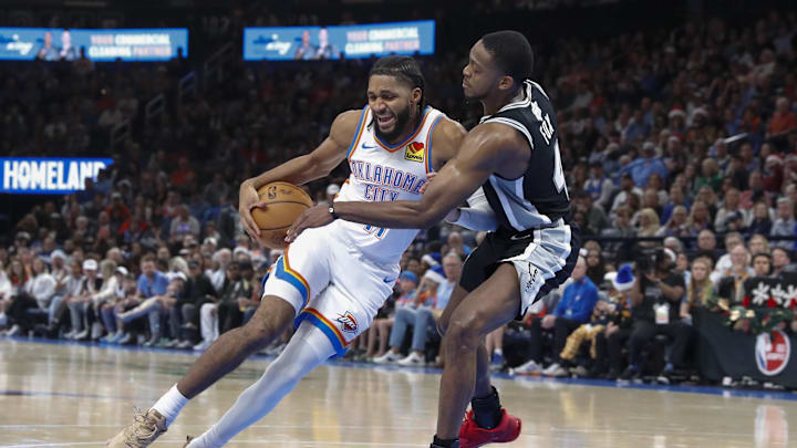 Dec 25, 2025; Oklahoma City, Oklahoma, USA; Oklahoma City Thunder guard Isaiah Joe (11) is defended by San Antonio Spurs guard De'Aaron Fox (4) on a drive during the second half at Paycom Center. Mandatory Credit: Alonzo Adams-Imagn Images