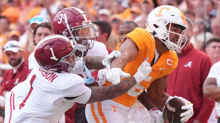 Tennessee wide receiver Bru McCoy (5) tries to fight off Alabama defensive backs Domani Jackson (1) and Keon Sabb (3) during an NCAA college football game on Saturday, Oct. 19, 2024, in Knoxville. Tenn.