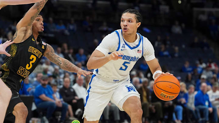 Memphis' Curtis Givens III (5) looks to pass the ball as Wichita State's Dre Kindell (3) guards him during the game between Wichita State and the University of Memphis at FedExForum on February 26, 2026.