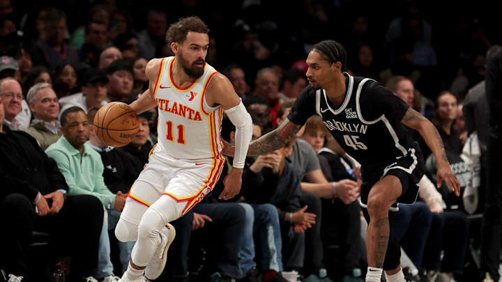 Apr 10, 2025; Brooklyn, New York, USA; Atlanta Hawks guard Trae Young (11) controls the ball against Brooklyn Nets guard Keon Johnson (45) during the second quarter at Barclays Center. Mandatory Credit: Brad Penner-Imagn Images