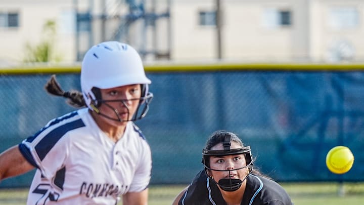 Evie Martin of Eau Gallie scores as Taylor Holtz of Rockledge fields a grounder in the District 8-4A softball final on April 30, Martin went 2-for-3 with one run scored and three RBI to propel the Commodores to a 9-2 victory.