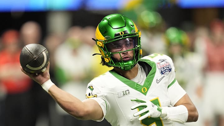 Jan 9, 2026; Atlanta, GA, USA; Oregon Ducks quarterback Dante Moore (5) throws a pass during the fourth quarter the 2025 Peach Bowl and semifinal game of the College Football Playoff at Mercedes-Benz Stadium. Mandatory Credit: Dale Zanine-Imagn Images