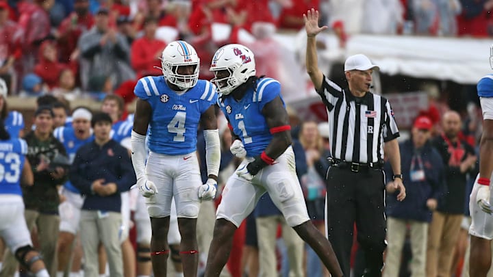Nov 9, 2024; Oxford, Mississippi, USA; Mississippi Rebels linebacker Suntarine Perkins (4) reacts with defensive lineman Princely Umanmielen (1) after a defensive stop during the first half against the Georgia Bulldogs at Vaught-Hemingway Stadium. Mandatory Credit: Petre Thomas-Imagn Images