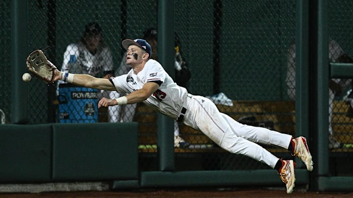 Jun 15, 2024; Omaha, NE, USA;  Texas A&M Aggies left fielder Caden Sorrell (13) attempts a diving catch against the Florida Gators during the seventh inning at Charles Schwab Field Omaha. Mandatory Credit: Steven Branscombe-Imagn Images