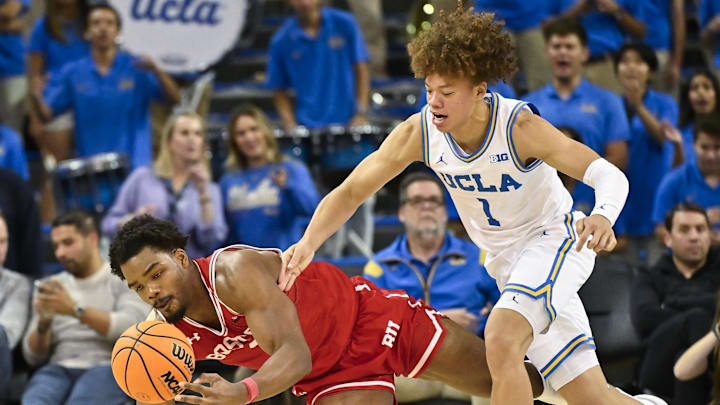 Nov 11, 2024; Los Angeles, California, USA; Boston University Terriers forward Malcolm Chimezie (3) and UCLA Bruins guard Trent Perry (1) chase down a loose ball during the second half at Pauley Pavilion presented by Wescom. Mandatory Credit: Robert Hanashiro-Imagn Images


