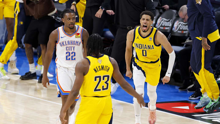 Jun 5, 2025; Oklahoma City, Oklahoma, USA; Indiana Pacers guard Tyrese Haliburton (0) and forward Aaron Nesmith (23) celebrate after Haliburton makes the game winning shot as Oklahoma City Thunder guard Cason Wallace (22) looks on during the fourth quarter during game one of the 2025 NBA Finals at Paycom Center. Mandatory Credit: Alonzo Adams-Imagn Images