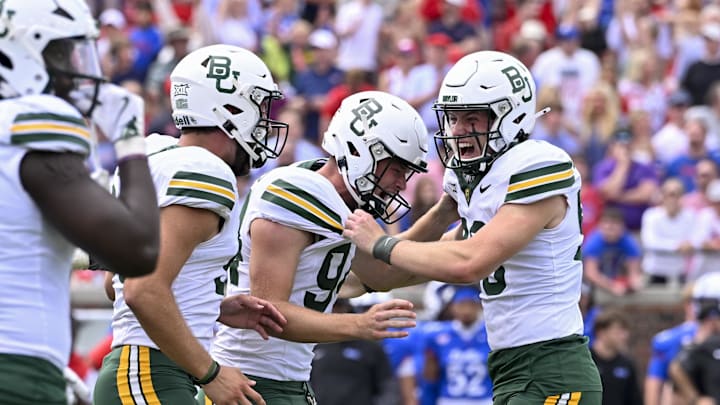 Baylor Bears punter Palmer Williams (94) celebrates after place kicker Connor Hawkins (96) makes a game winning field goal to defeat the SMU Mustangs during the second overtime at Gerald J. Ford Stadium
