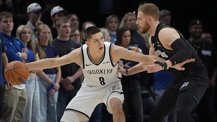 Dec 27, 2025; Minneapolis, Minnesota, USA; Brooklyn Nets guard Egor Demin (8) works around Minnesota Timberwolves guard Donte DiVincenzo (0) in the first quarter at Target Center. Mandatory Credit: Bruce Kluckhohn-Imagn Images