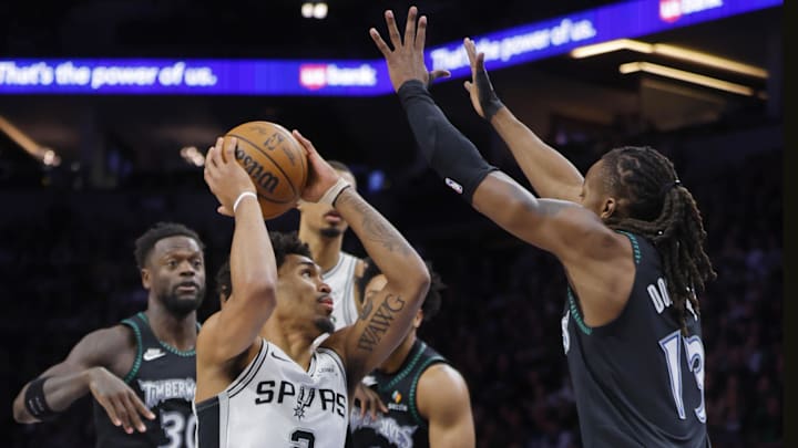 May 10, 2026; Minneapolis, Minnesota, USA; San Antonio Spurs guard Dylan Harper (2) goes to the basket between Minnesota Timberwolves forward Julius Randle (30) and guard Terrence Shannon Jr. (1) and guard Ayo Dosunmu (13) in the first quarter of game four of the second round of the 2026 NBA Playoffs at Target Center. Mandatory Credit: Bruce Kluckhohn-Imagn Images
