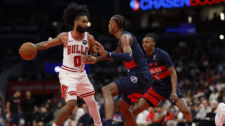Nov 26, 2024; Washington, District of Columbia, USA; Chicago Bulls guard Coby White (0) passes the ball as Washington Wizards forward Alexandre Sarr (20) defends in the fourth quarter at Capital One Arena. Mandatory Credit: Geoff Burke-Imagn Images