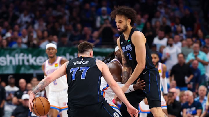 May 18, 2024; Dallas, Texas, USA; Oklahoma City Thunder guard Luguentz Dort (5) fouls Dallas Mavericks center Dereck Lively II (2) as Dallas Mavericks guard Luka Doncic (77) dribbles during the second quarter in game six of the second round of the 2024 NBA playoffs at American Airlines Center. Mandatory Credit: Kevin Jairaj-Imagn Images May 18, 2024; Dallas, Texas, USA; Oklahoma City Thunder guard Luguentz Dort (5) fouls Dallas Mavericks center Dereck Lively II (2) as Dallas Mavericks guard Luka Doncic (77) dribbles during the second quarter in game six of the second round of the 2024 NBA playoffs at American Airlines Center. Mandatory Credit: Kevin Jairaj-Imagn Images