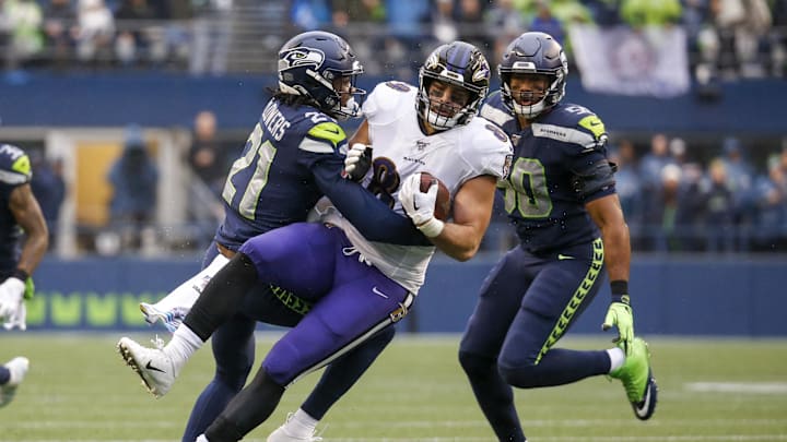 Oct 20, 2019; Seattle, WA, USA; Seattle Seahawks cornerback Tre Flowers (21) tackles Baltimore Ravens tight end Mark Andrews (89) after making a reception during the second quarter at CenturyLink Field. Mandatory Credit: Joe Nicholson-Imagn Images