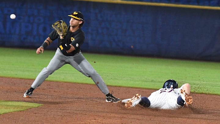 Auburn base runner Bobby Peirce slides into second for a steal as Missouri infielder Matt Garcia