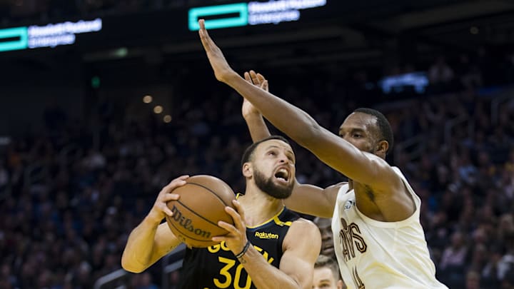 Dec 30, 2024; San Francisco, California, USA;  Cleveland Cavaliers forward Evan Mobley (4) defends against Golden State Warriors guard Stephen Curry (30) during the second quarter at Chase Center. Mandatory Credit: John Hefti-Imagn Images