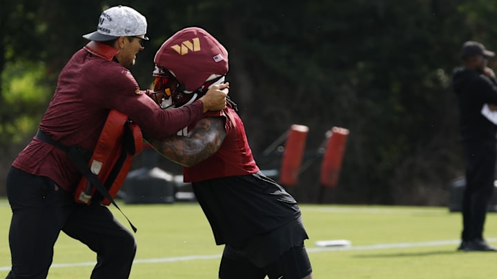 Washington Commanders linebacker Frankie Luvu participates in a drill. Washington Commanders linebacker Frankie Luvu participates in a drill.