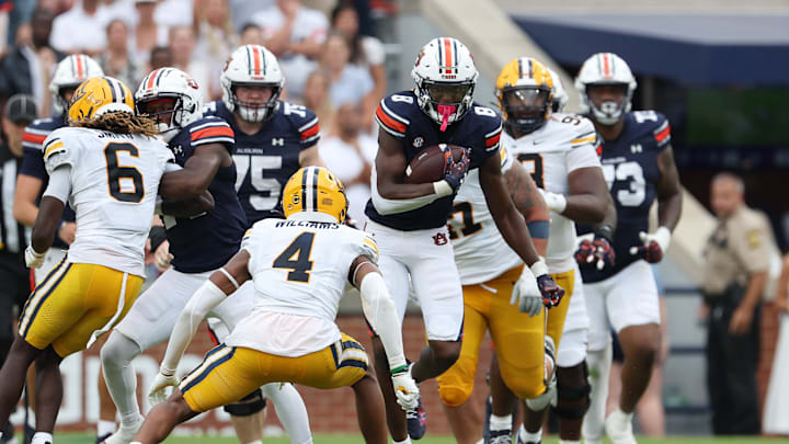 Sep 7, 2024; Auburn, Alabama, USA;  California Golden Bears defensive back Miles Williams (4) closes in on Auburn Tigers wide receiver Cam Coleman during the fourth quarter at Jordan-Hare Stadium. Mandatory Credit: John Reed-Imagn Images