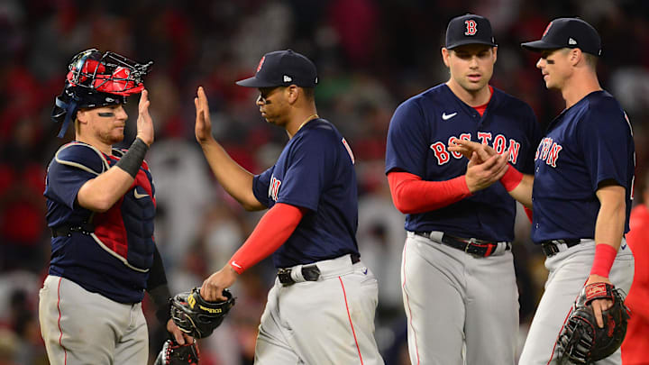 Jul 5, 2021; Anaheim, California, USA; Boston Red Sox catcher Christian Vazquez (7) third baseman Rafael Devers (11) relief pitcher Adam Ottavino (0) and first baseman Bobby Dalbec (29) celebrate the 5-4 victory against the Los Angeles Angels  at Angel Stadium. Mandatory Credit: Gary A. Vasquez-Imagn Images
