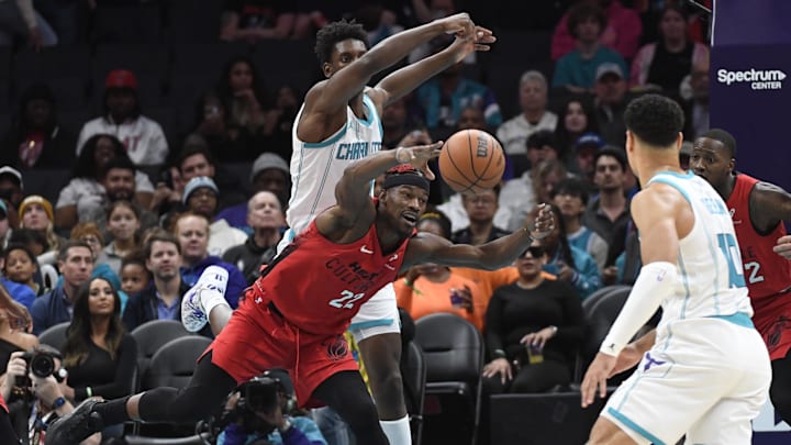 Nov 27, 2024; Charlotte, North Carolina, USA;  Miami Heat forward Jimmy Butler (22) goes after a loose ball during the first half against the Charlotte Hornets at the Spectrum Center. Mandatory Credit: Sam Sharpe-Imagn Images