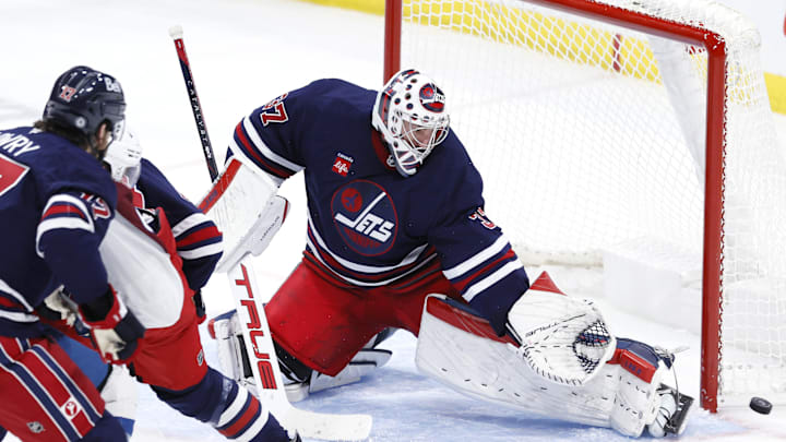 Nov 7, 2024; Winnipeg, Manitoba, CAN; Winnipeg Jets goaltender Connor Hellebuyck (37) makes a pad save in the third period against the Colorado Avalanche at Canada Life Centre. Mandatory Credit: James Carey Lauder-Imagn Images