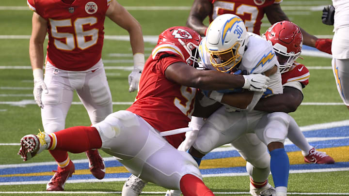 Sep 20, 2020; Inglewood, California, USA; Los Angeles Chargers running back Austin Ekeler (30) is tackled by Kansas City Chiefs nose tackle Derrick Nnadi (91) during the fourth quarter at SoFi Stadium. Mandatory Credit: Robert Hanashiro-Imagn Images