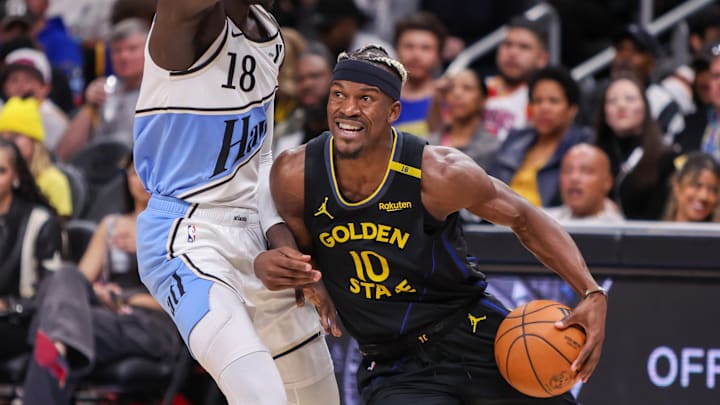 Mar 22, 2025; Atlanta, Georgia, USA; Golden State Warriors forward Jimmy Butler III (10) drives on Atlanta Hawks forward Mouhamed Gueye (18) in the third quarter at State Farm Arena. Mandatory Credit: Brett Davis-Imagn Images